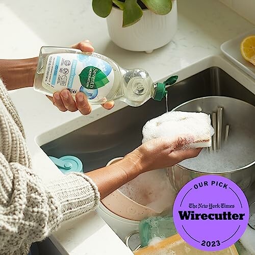 Person washing dishes with soap, endorsed by Wirecutter.