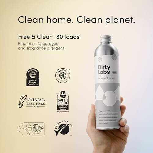 Hand holding Dirty Labs laundry detergent with eco-friendly labels.