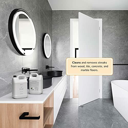 Modern bathroom with cleaning products and mirrors.