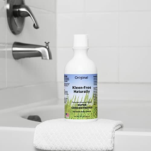 Natural cleaner bottle on a white towel in a bathroom setting.